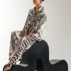"Women's off-white co-ord set with black and red floral print, featuring a short button-down top with quarter sleeves and matching straight-fit trousers – elegant 2-piece outfit"