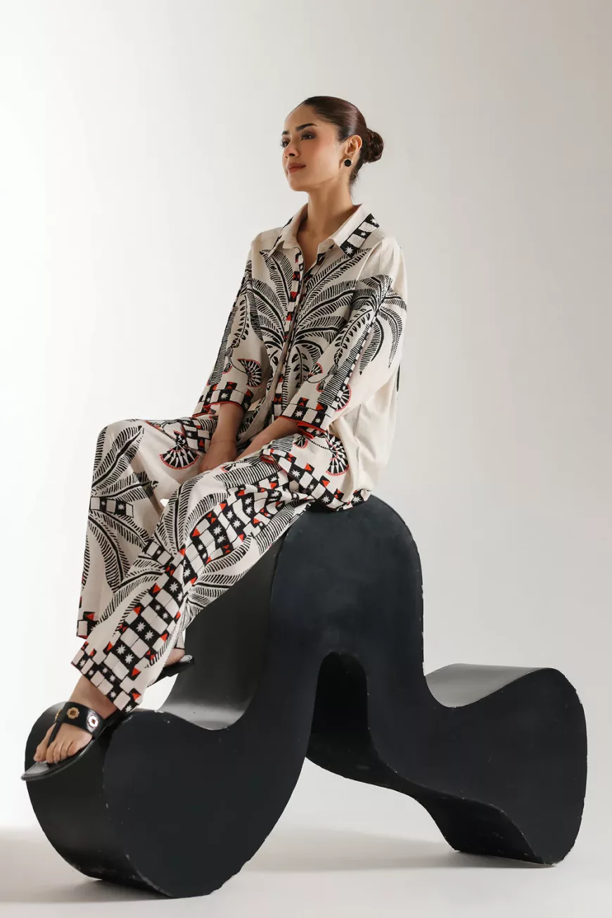 "Women's off-white co-ord set with black and red floral print, featuring a short button-down top with quarter sleeves and matching straight-fit trousers – elegant 2-piece outfit"
