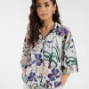 "Women's white cropped shirt with colorful floral print, button-down front, and cotton linen fabric – stylish party-ready 1-piece top"