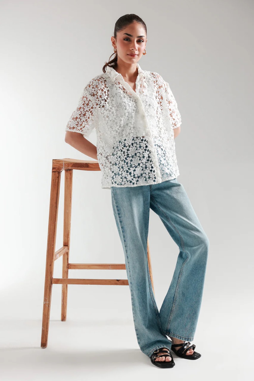 Model wearing white cutwork short sleeve button-down top