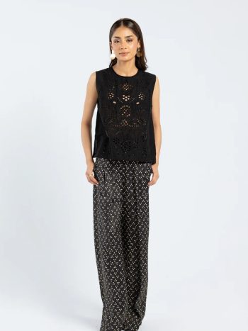 Model wearing jet black sleeveless embroidered kurti with schiffli details